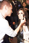 Super center: Cindy Crawford gets the attention backstage at Roberto Cavalli. 